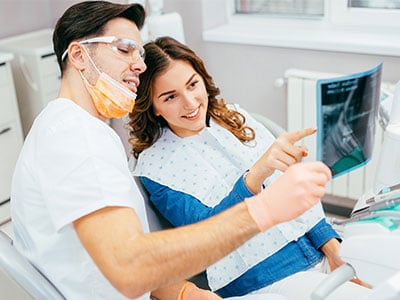 Dentist showing patient her x-ray