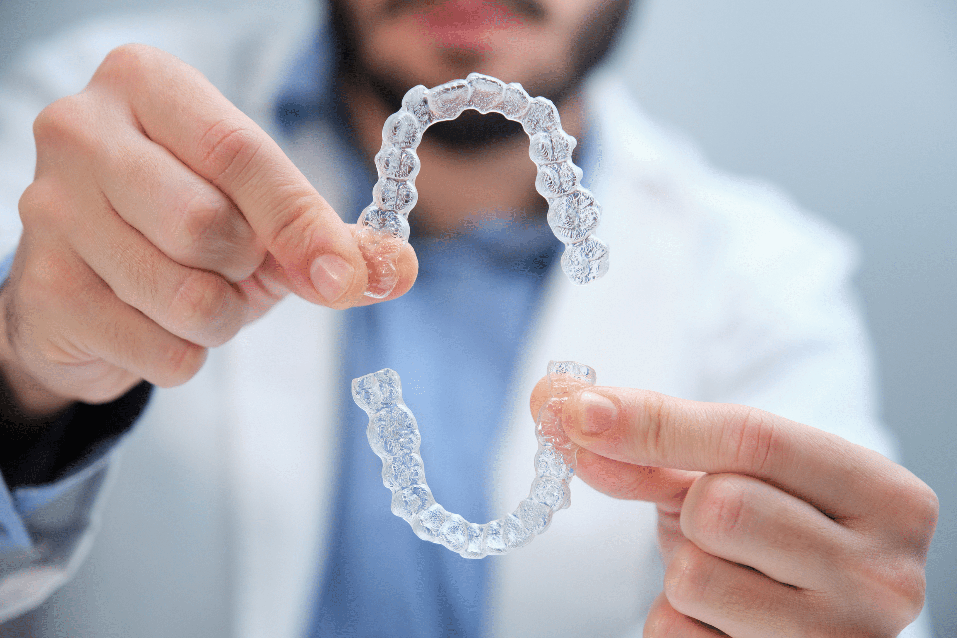 Clear aligners held by an orthodontic provider for adults considering Invisalign after 40 in Baton Rouge LA